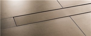 The Schluter-KERDI-LINE is a low profile linear floor drain specifically designed for bonded waterproofing assemblies. KERDI-LINE can be installed adjacent to walls or at intermediate locations in showers, wet rooms, and other applications that require waterproofing and drainage. The floor can be sloped on a single plane to KERDI-LINE, which enables the use of large-format tiles and creates interesting design opportunities. The KERDI-LINE channel body is made of formed stainless steel and features a collar made of Schluter-KERDI for a secure waterproof connection. The tileable covering support can accommodate any thickness of tile covering.
