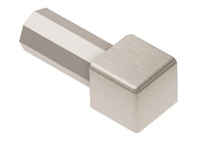 Schluter-QUADEC is a finishing and edge-protection profile for the outside corners of tiled surfaces. It features a trapezoid-perforated anchoring leg that is secured in the mortar bond coat beneath the tile and a reveal that forms a square outer corner along the surface edge. The profile is available in stainless steel, stainless steel with structured finish, anodized aluminum and textured color-coated aluminum. QUADEC allows for modern decorative design and interesting contrasts. The profile can be combined with the QUADEC-FS feature strip profile and the DESIGNLINE border profile for further design options. In addition to its decorative effect, the profile protects tile edges against damage caused by mechanical stresses. QUADEC, in stainless steel, is particularly resistant to wear when used as edge protection. It may also be used as a stair nosing or floor transition profile. In addition, QUADEC is suitable for transitions, corners, or dado coverings with other covering materials; for example, carpet, parquetry, natural stone tiles, or poured epoxy coverings. The integrated joint spacer forms a defined joint cavity with the tile.
